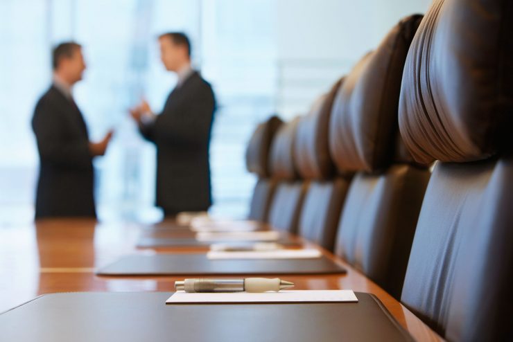 Two men talking in a conference room